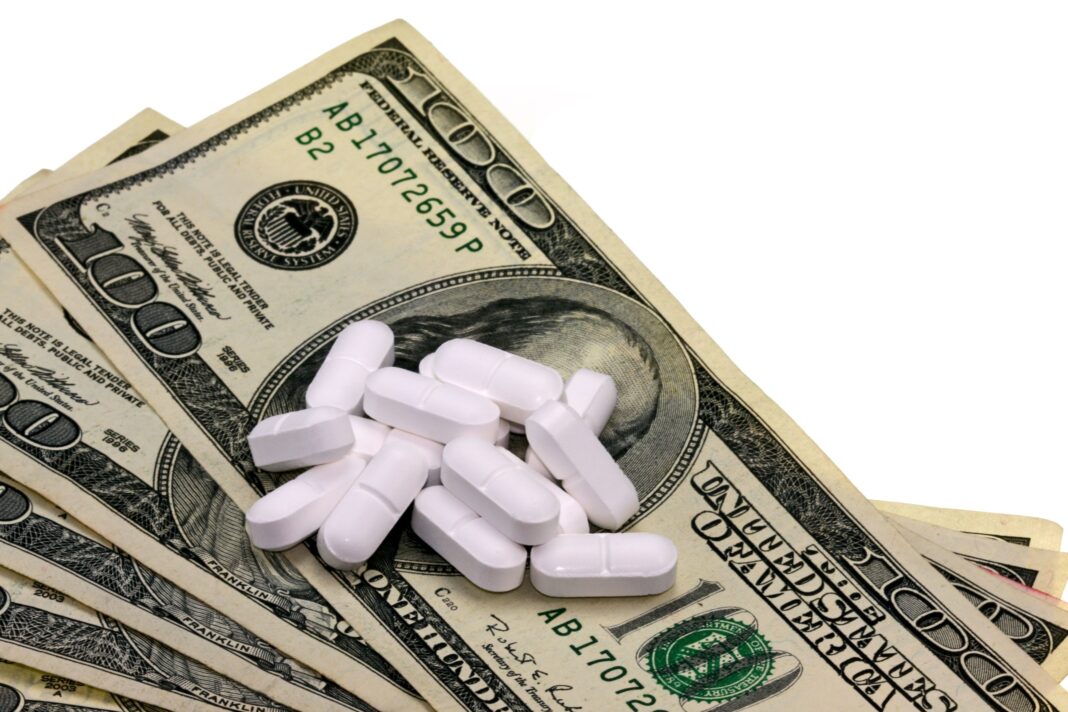 White tablets placed on U.S. dollar bills symbolizing drug trafficking and illegal profits